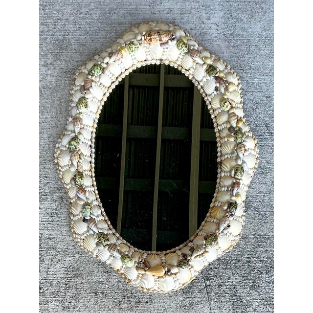 Bring the serenity of the seaside into your home with this exquisite vintage shell-encrusted wall mirror. Reminiscent of...