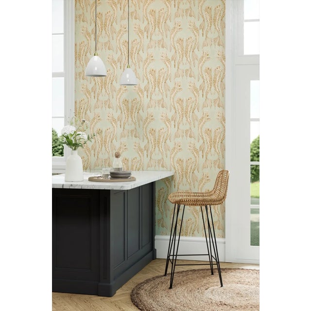 With its mica scales glimmering softly against a translucent painterly ground the formal art deco layout of this wallpaper...
