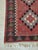 vintage-style Turkish kilim runner rug features a striking geometric tribal design with five large diamond medallions...