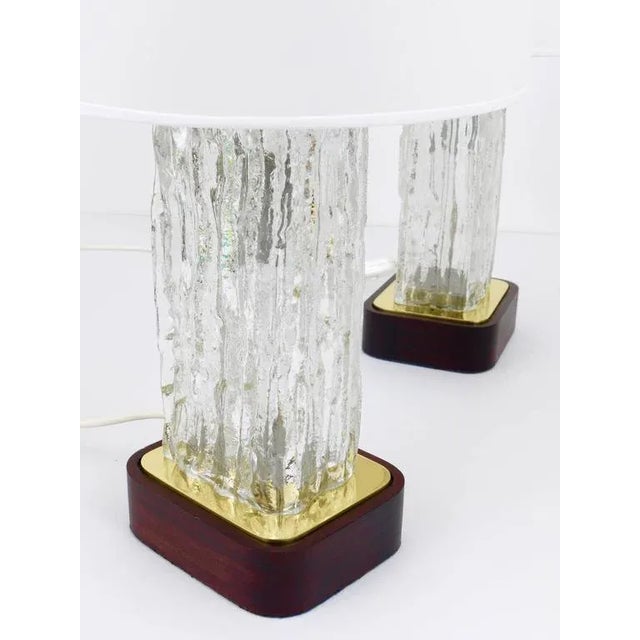 A pair of beautiful and rare table lamps, manufactured in the 1950s by Kalmar Austria. The lamps have wonderful ice glass...
