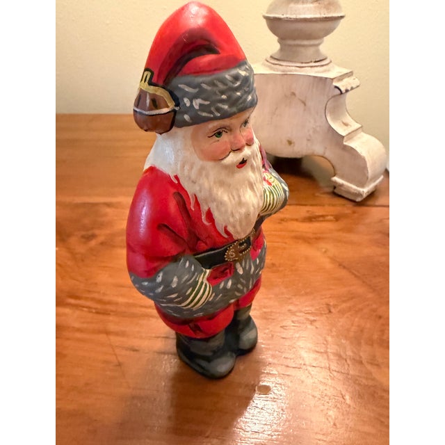 This is an “American Santa,” from Vaillancourt Folk Art, 1994. He is special. He has fabulous striped mittens and his...
