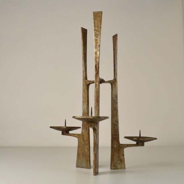 Sculptural forged steel candelabra made in the 1960's looks monumental and architectural. It has three arms is suitable...