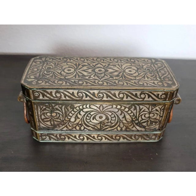 A scarce fine quality antique Filipino silver-inlaid solid brass betel nut box, dating to the second half of the 19th /...