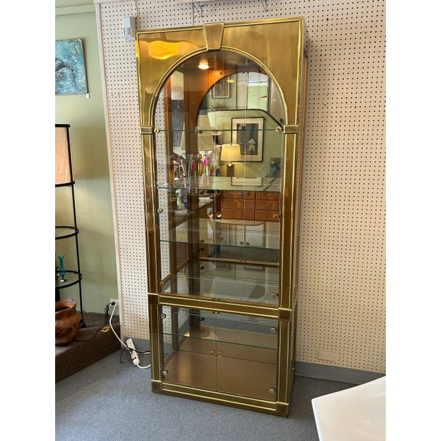 You are viewing a fantastic Brass + Glass Lighted Display Cabinet, designed Styled After Mastercraft c1993. The design...