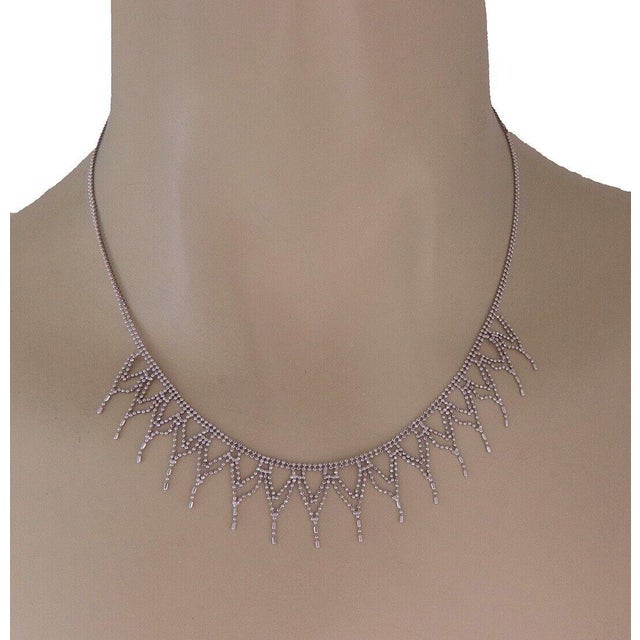 This is an elegant contemporary style necklace, it is 14k white gold tiny diamond cut beads featuring a double chain with...