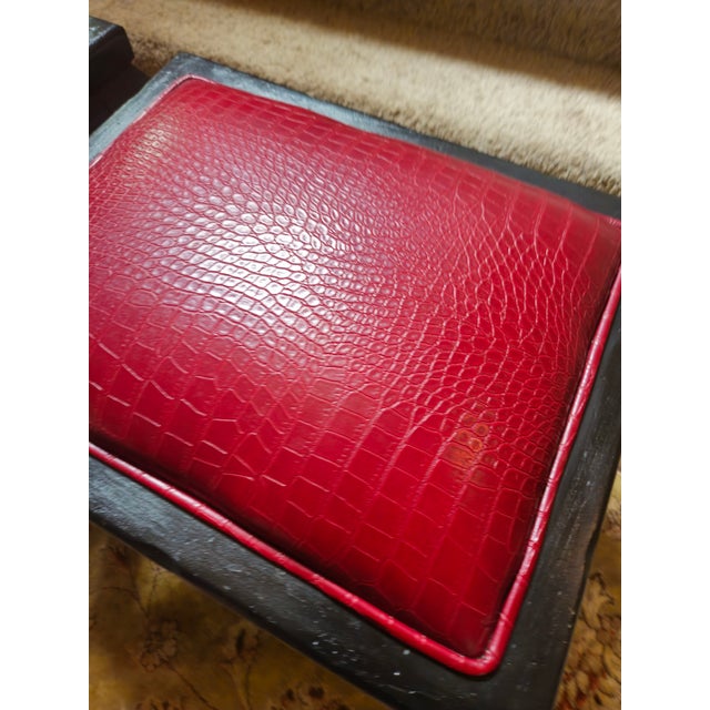 A rich looking vintage faux crocodile embossed leather ottoman in a wonderful shade of red and having contemporary Queen...
