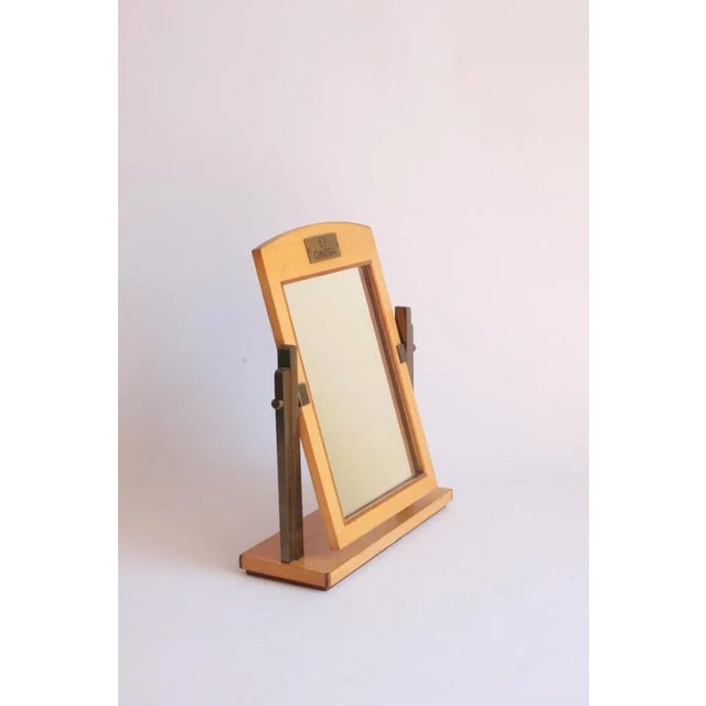 Art deco dealers boutique mirror for omega watches, Switzerland 1940s. Wood and brass. The mirror can be aimed. This piece...