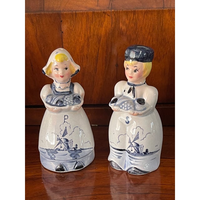 Vintage pair of Delft Holland salt and pepper shakers in a shape of folklore couple..
