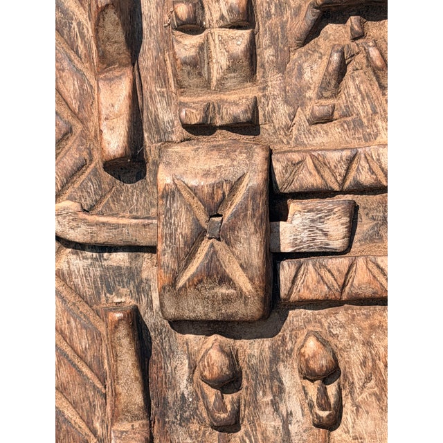 Authentic, mid-20th-century hand-carved wooden granary door from the Dogon people of Mali, West Africa. This exceptional...
