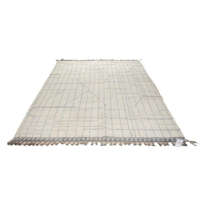 This hand knotted pile rug features a primary color palette of ivory, beige, cream, and white. Crafted from wool, this...