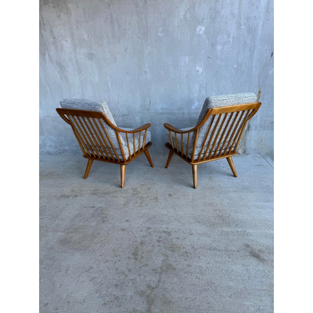 A pair of solid maple lounge chairs by Conant Ball, restored in our Seattle workshop. Their curved arms and spindle backs...