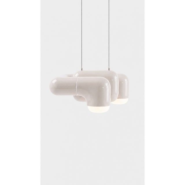 A pendant light with real character in a small footprint. Curved printed tiles interlock into a low, wide shade that seems...