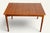 Elegant 1960s teak dining table in Scandinavian style. Its rectangular top with its warm grain rests on four tapered legs,...