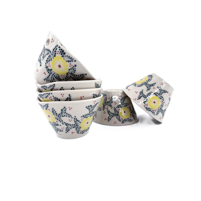 A charming set of six Bat Trang ceramic bowls, crafted in Vietnam and decorated with a lively floral motif in sunny...