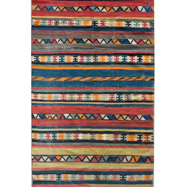 A wonderful early 20th century Persian Shahsevan kilim runner with myriad multi-colored stripes, some solid, and some with...