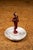 Art Deco figural ashtray attributed to J. B. Hirsch, featuring a cold-painted metal female figure mounted at the center of...