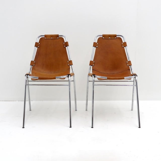 Iconic leather and metal side chairs selected by Charlotte Perriand for the Ski resort Les Arcs in 1960, with chrome...