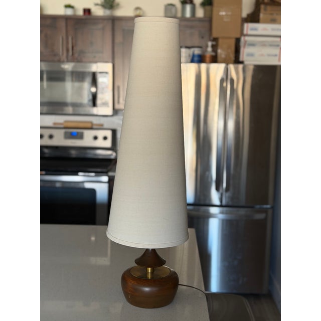 Mid-Century Modern walnut and brass table lamp by Modeline of California, produced in the 1960s. This sculptural lamp...