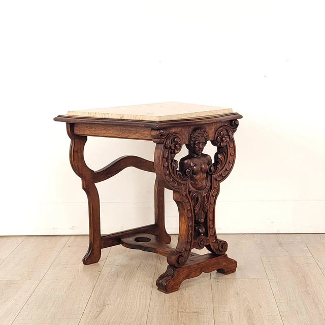 A Renaissance Revival marble top side table with a beauty carved in front, 1920s.