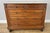 An elegant Antique French chest of drawers in walnut, featuring a white marble top, five drawers and beautifully detailed...