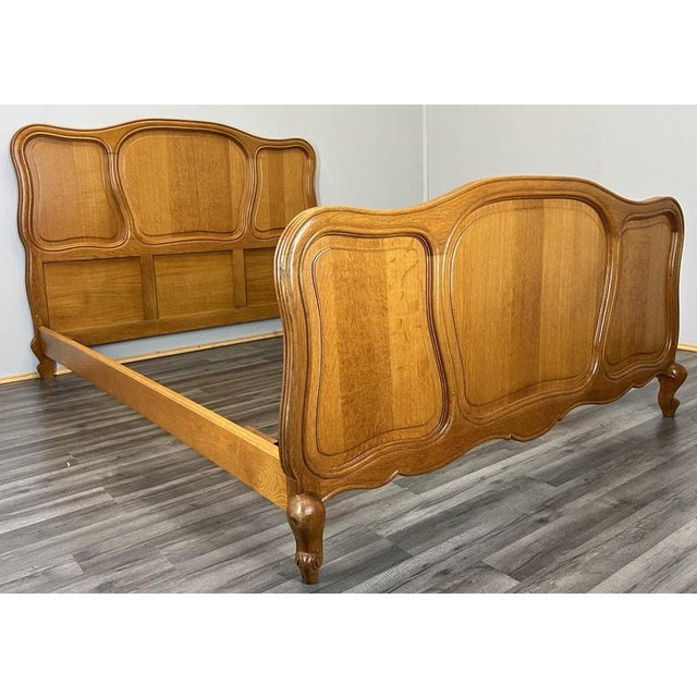 This Vintage French Louis double bed frame presents a beautifully shaped and elegantly curved design, featuring warm oak...