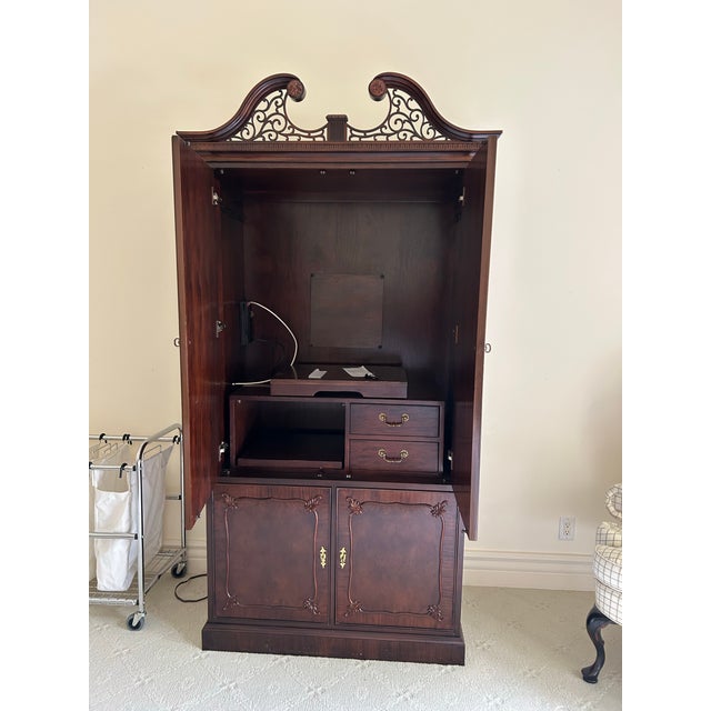 Elegant Century Furniture mahogany armoire featuring a rich, warm finish, carved detailing, and spacious interior storage....
