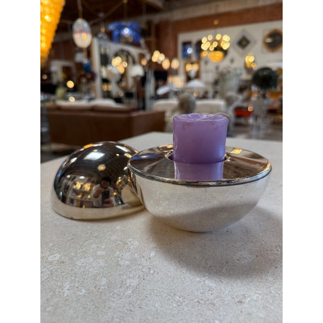 Sleek and sculptural vintage candle holder featuring a polished chrome spherical form with a fitted domed snuffer lid. The...