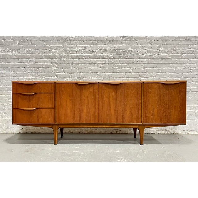 This stunning mid century modern teak sideboard, designed by Tom Robertson for A.H. McIntosh of Scotland in the early...
