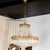 An elegant Empire-style pendant lamp, dating from the 1960s, combining refinement and luminosity. The structure is made of...
