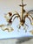 Vintage Italian chandelier featuring a gilt metal frame with floral and foliate decoration. The chandelier is fitted with...