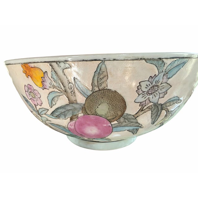A beautiful vintage porcelain bowl decorated with an intricate fruit, blossom, and foliage motif in soft shades of celadon...