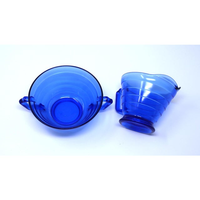 This vibrant cobalt blue depression glass sugar and creamer by Hazel Atlas would be a great addition to any collection....