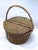 Vintage double lidded carrying basket with handle. Half a lid on each side hinged with leather. No maker's marks.