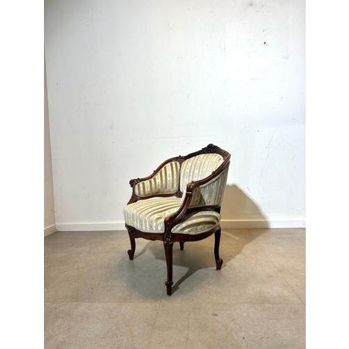 Charming antique Rococo style armchair with a finely carved walnut frame and elegant cabriole legs. The chair is...