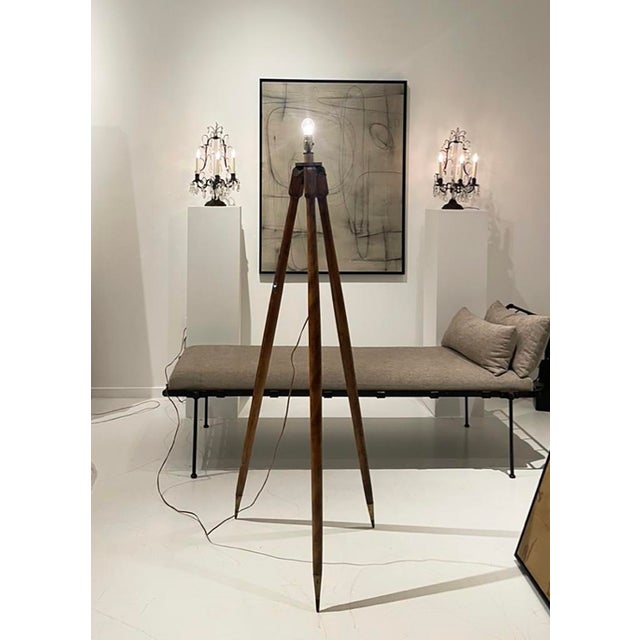 A striking early 20th-century surveyor’s tripod, thoughtfully converted into a sculptural floor lamp. This piece retains...
