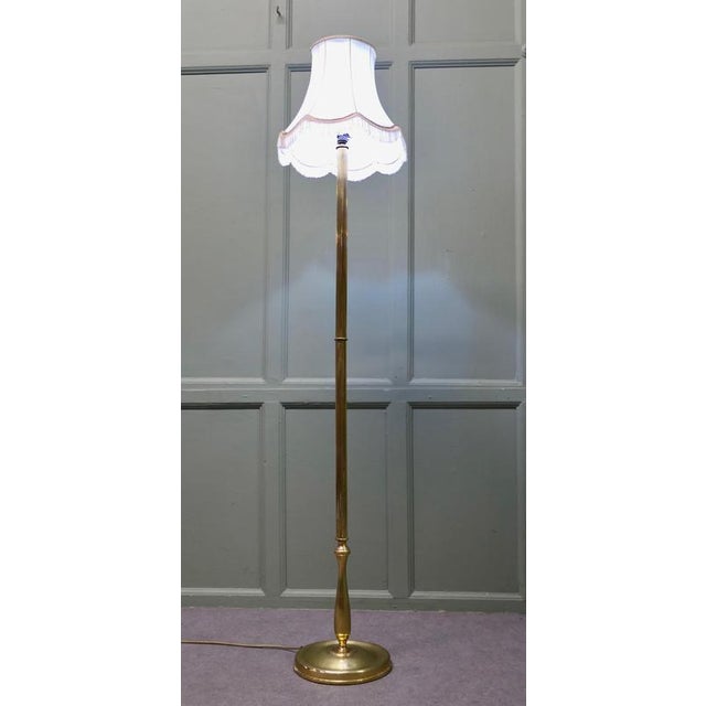 A Slender Column Brass Floor Lamp A lovely design it has a decorative circular base and a tall central column also in...