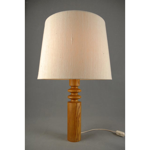 An unusually large table lamp designed by Uno Kristiansson for Luxus, Sweden, during the 1970s. The design reflects the...