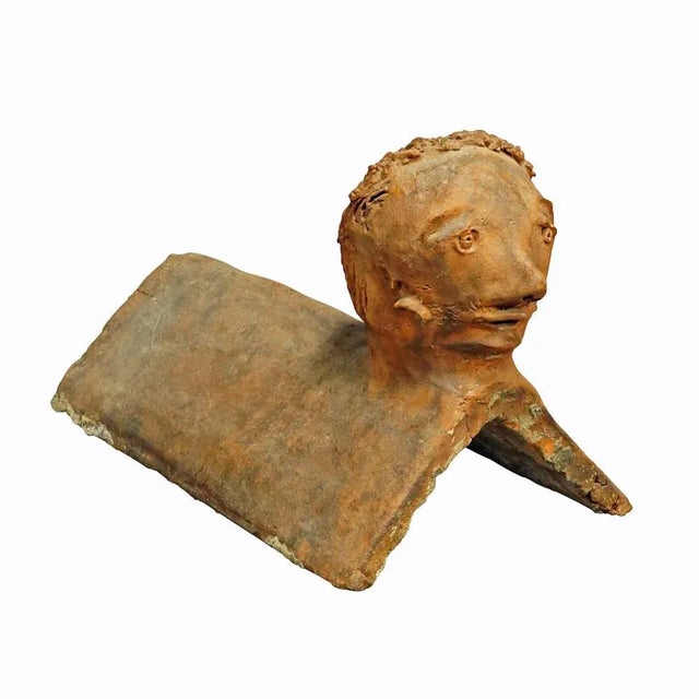 Antique Handmade Roof Rider Brick, Germany 1844 An antique roof rider made of clay featuring a head in outsider art style....