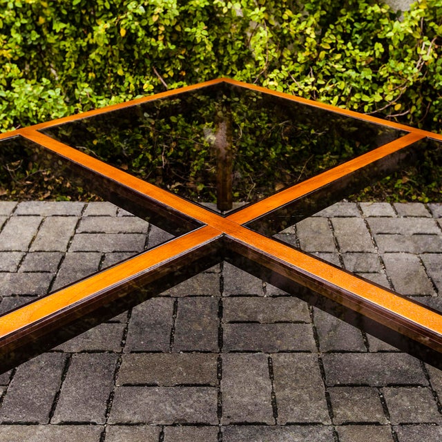 Large walnut and smoked glass coffee or cocktail table, purchased new in the early 1970s. The solid walnut frame has been...