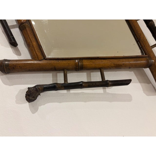 A natural bamboo wall mirror, imbued with the delicate charm of late 19th-century Japonisme. Its square, diamond-shaped...