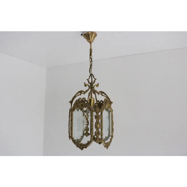 Bring romance into your home with this elegant French Louis XVI style hanging lantern from the 1950s. The finely cast...