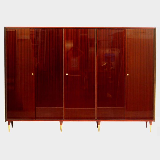 Large vintage mid century modern 5-door wardrobe in mahogany from the 1960s. This XL wardrobe rests on eight stylish legs...