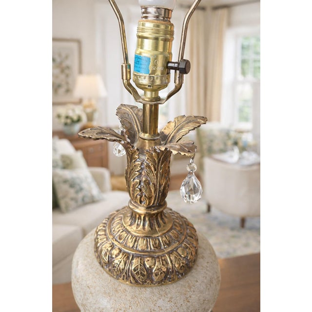 A stately and elegant Hollywood Regency table lamp dating to the 1950s, featuring a hand-decorated glass body with...