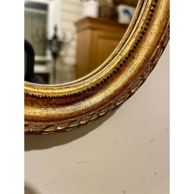 Vintage Petit Gilt Italian Mirror Measures 8" x 6.25" wide. Hanger on back for hanging. Mirror was brought to the states...