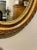 Vintage Petit Gilt Italian Mirror Measures 8" x 6.25" wide. Hanger on back for hanging. Mirror was brought to the states...