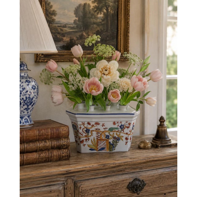 A distinctive mid-century Italian tulipiere or flower-frog vase, hand painted with an exuberant Chinoiserie garden scene....