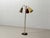 Elegant three-light floor lamp in a classic mid-century design. The lamp is characterized by its slender, vertical form...