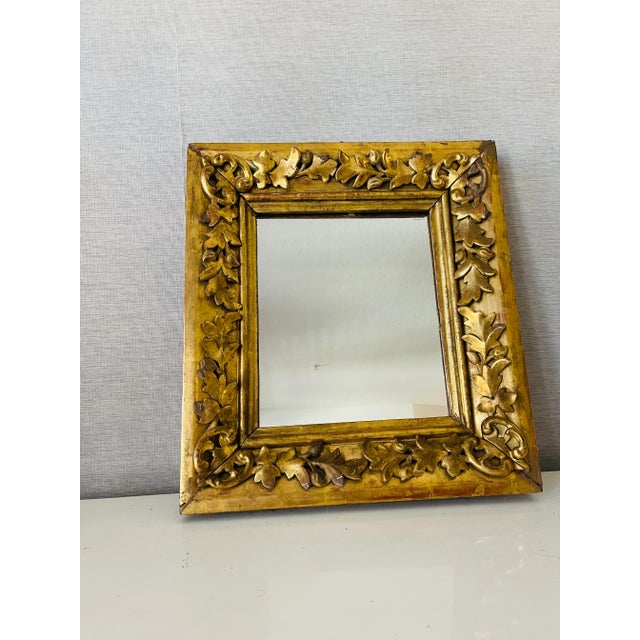 19 th c Heavily ornate handcarved wood gold leaf frame mirror.
