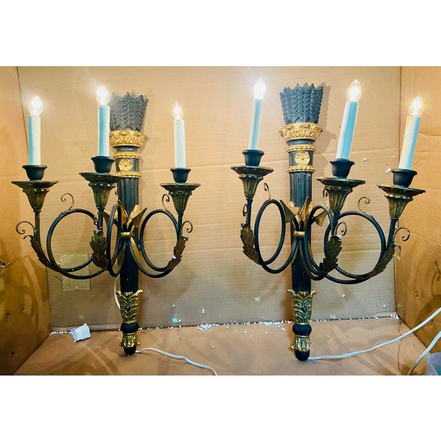This is a sweet pair of neoclassical style wall sconces with a stylized arrow motif which starts with the feather on the...