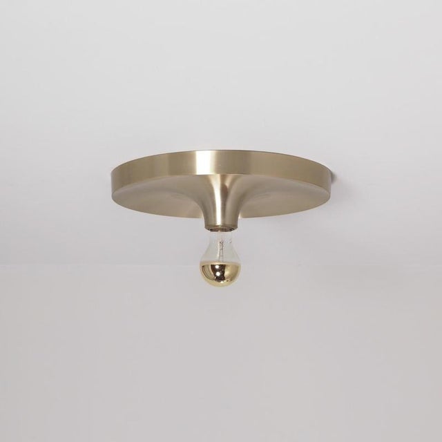 Space age ceiling light by teka in brass-coloured aluminium, featuring a circular disc-shaped shade with a gentle conical...